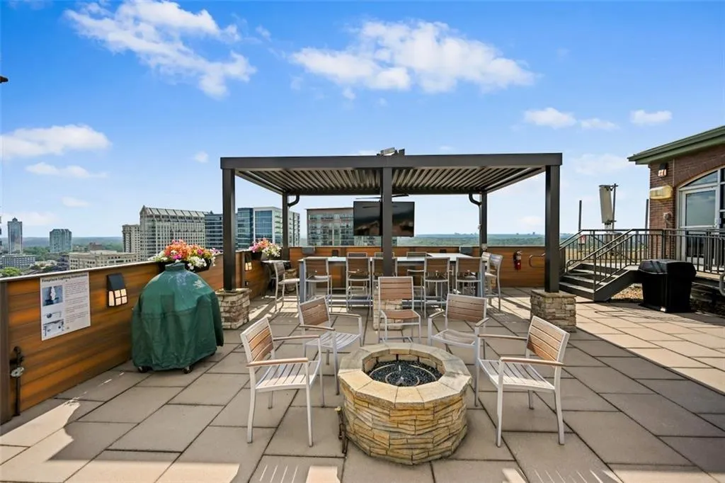 View of patio / terrace featuring an outdoor fire pit and grilling area