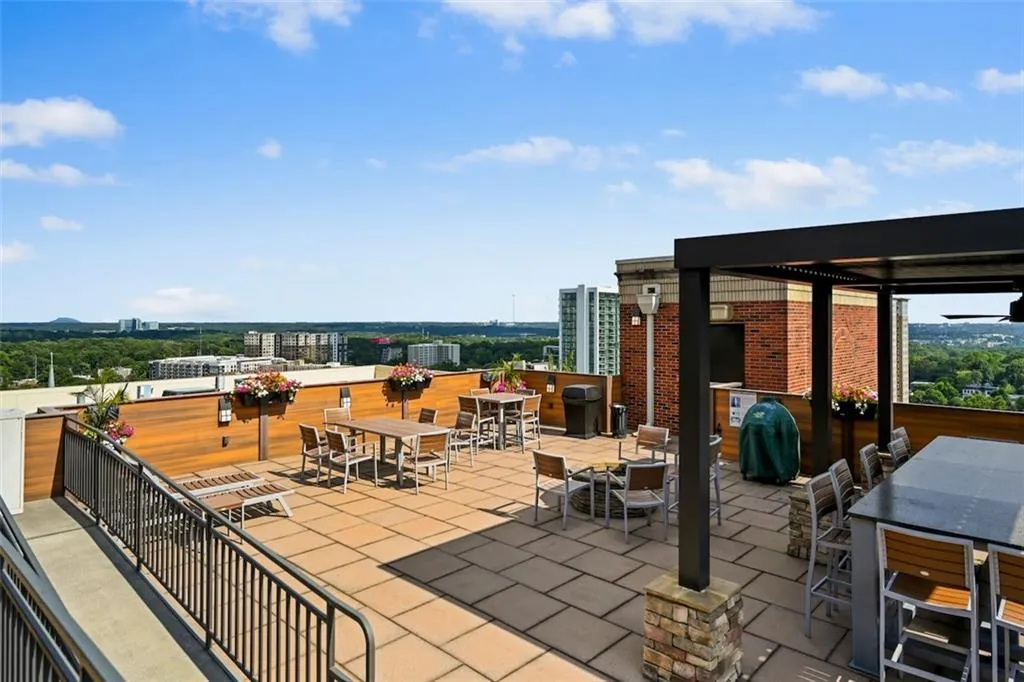View of patio / terrace featuring outdoor dining area, a view of city, and grilling area for community