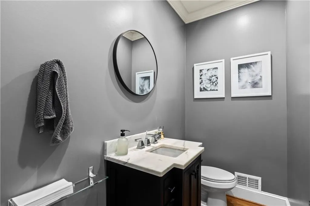 Bathroom with vanity and crown molding