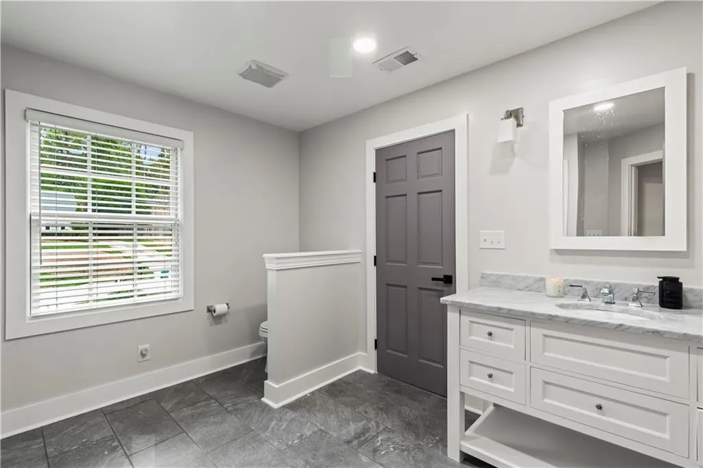 Bathroom featuring vanity and baseboards