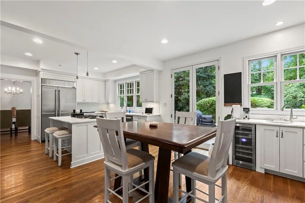 Dining space with recessed lighting, dark wood-type flooring, and wine cooler