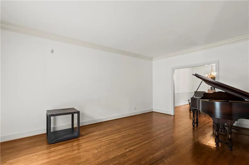 Living area featuring crown molding and wood finished floors