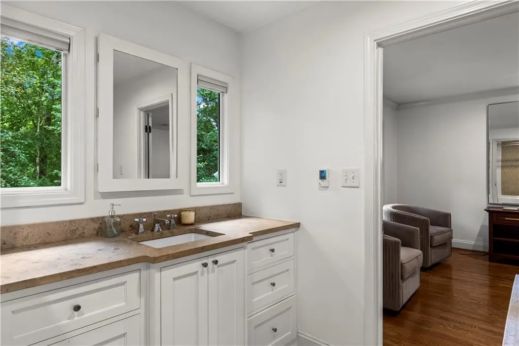 Bathroom featuring vanity and dark wood-style flooring