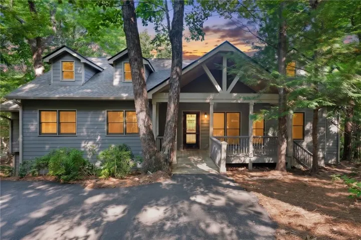 Craftsman-style exterior with gabled dormers and a covered front porch featuring a decorative truss