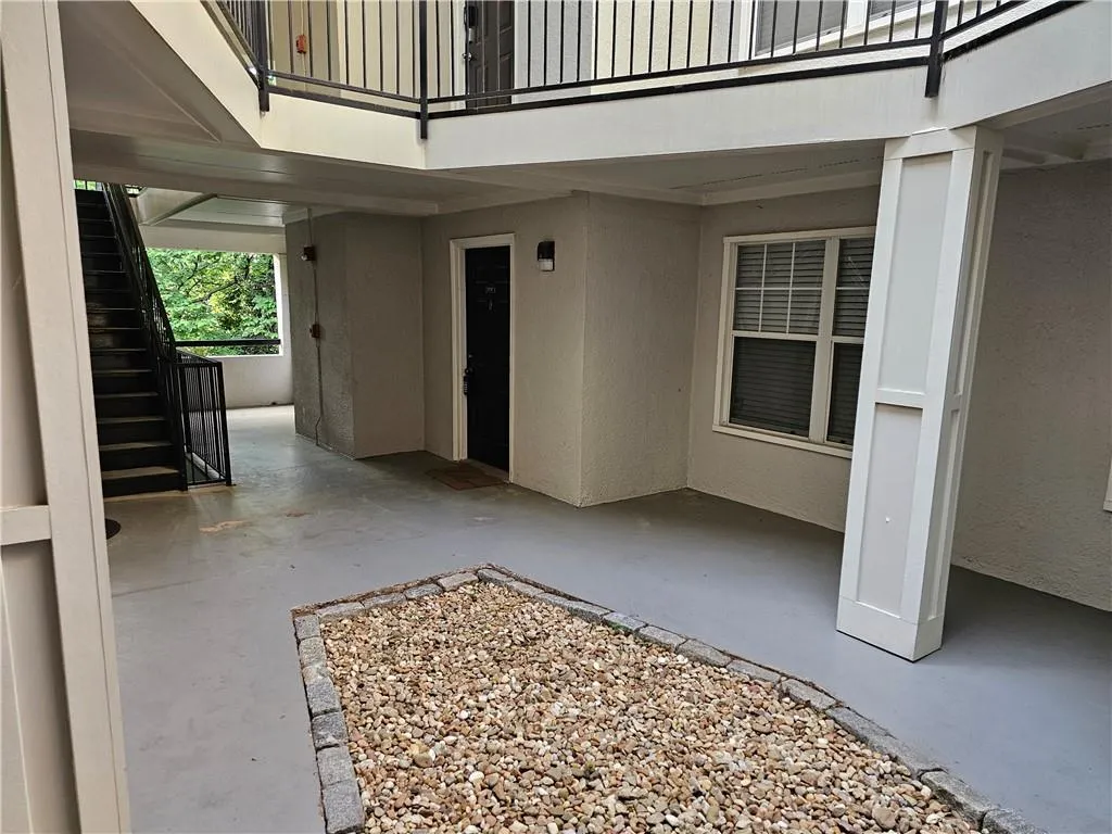 Property entrance with a patio and stucco siding