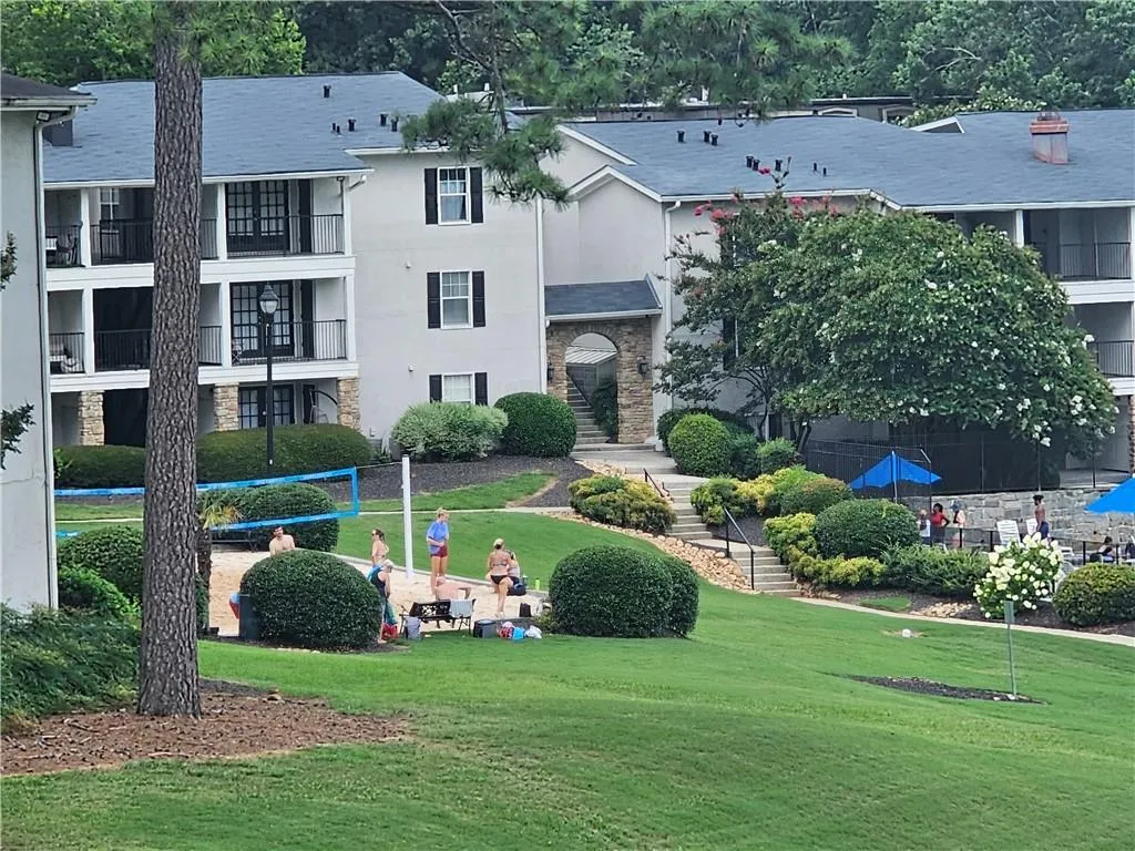 View of home's community with a yard and stairway