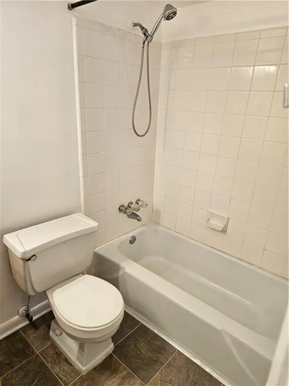 Full bathroom with toilet and shower / tub combination