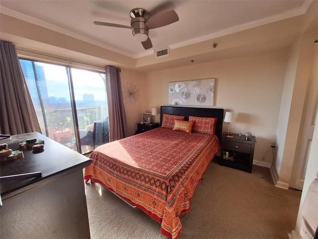 Bedroom featuring access to exterior, crown molding, ceiling fan, and carpet