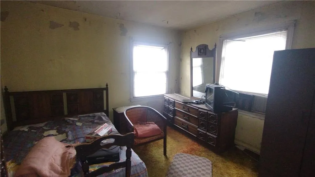Bedroom featuring multiple windows
