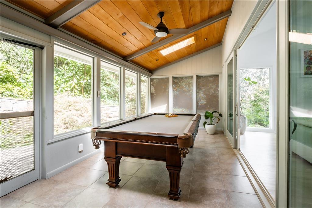 Rec room with pool table, light tile flooring, wood ceiling, and ceiling fan