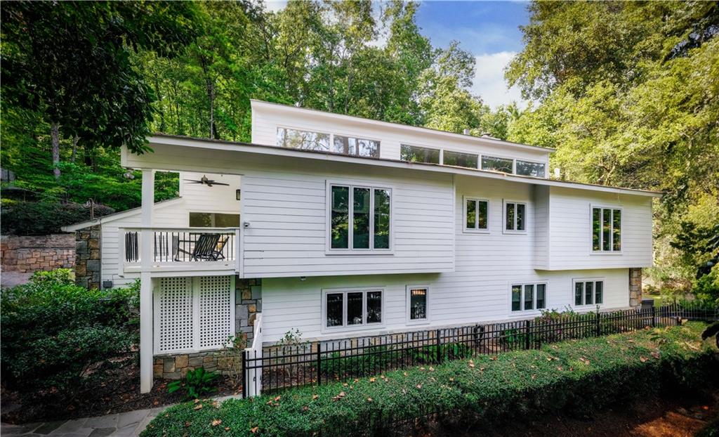 Back of property with a balcony