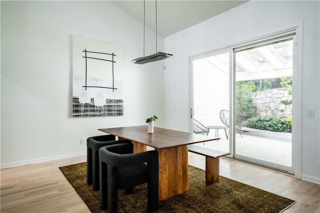 Dining room featuring light hardwood / wood-style flooring and lofted ceiling