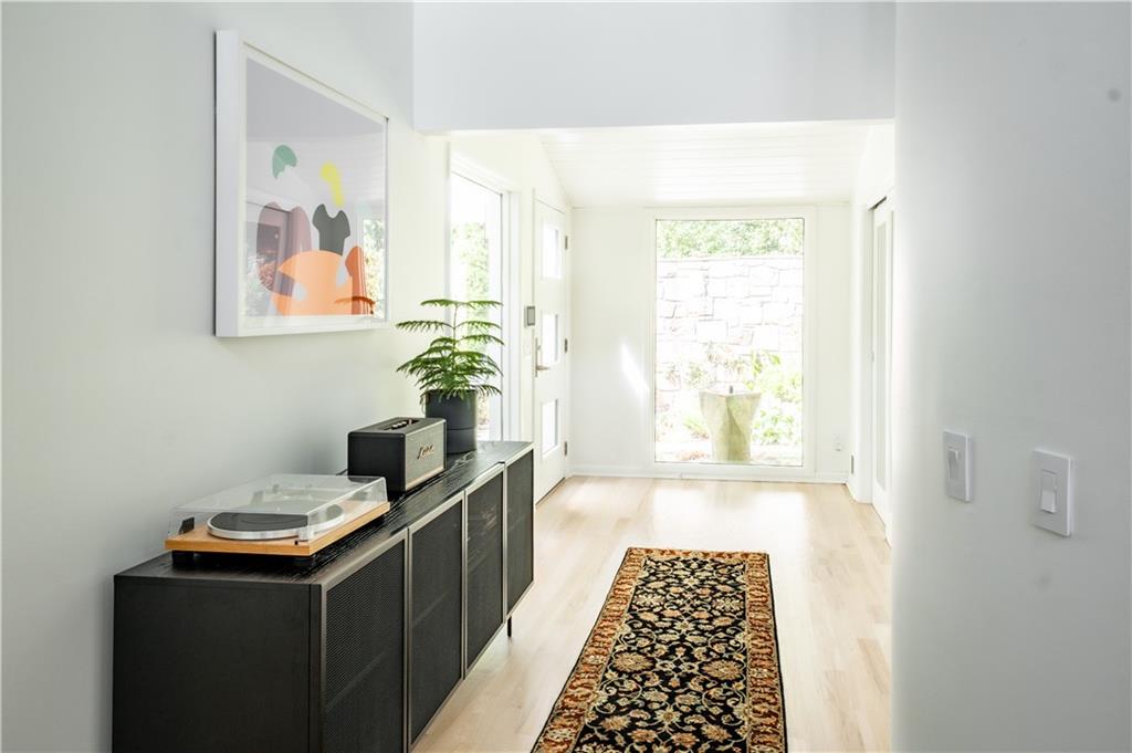 Hall with light hardwood / wood-style floors