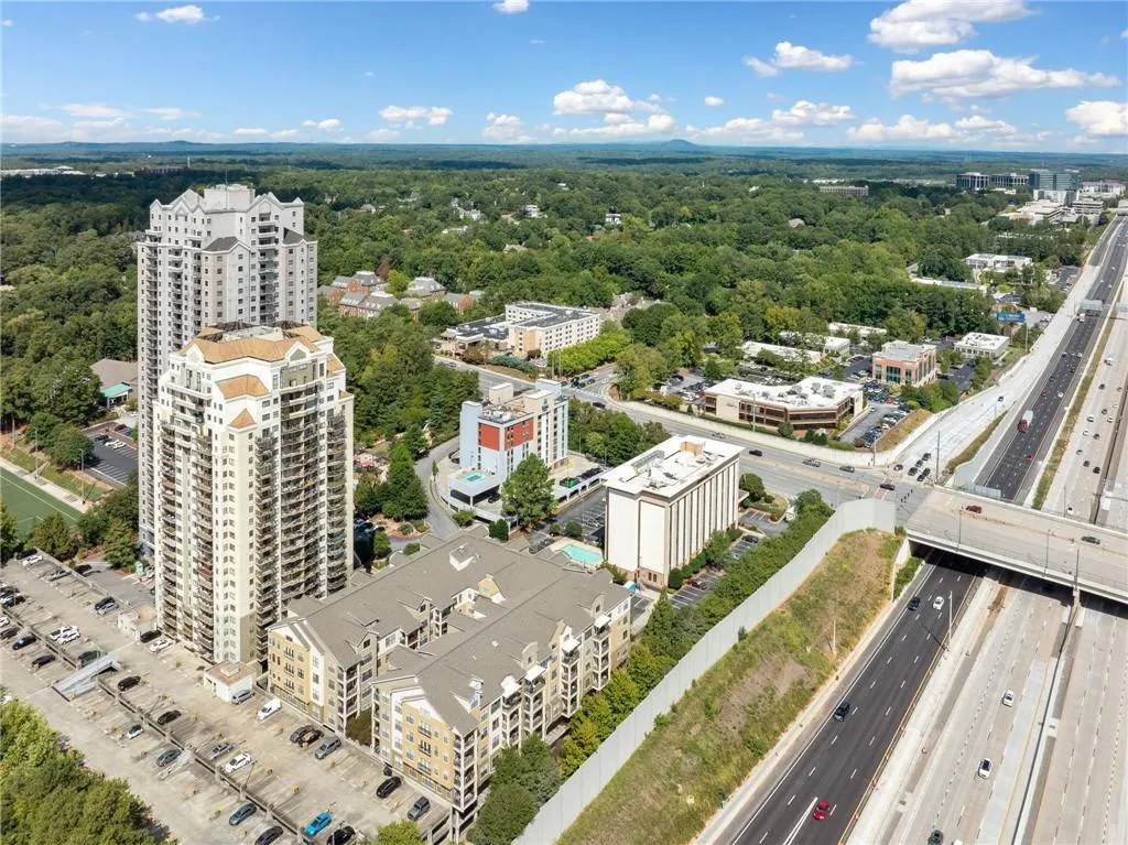 Drone / aerial view of a major roadway and a heavily wooded area