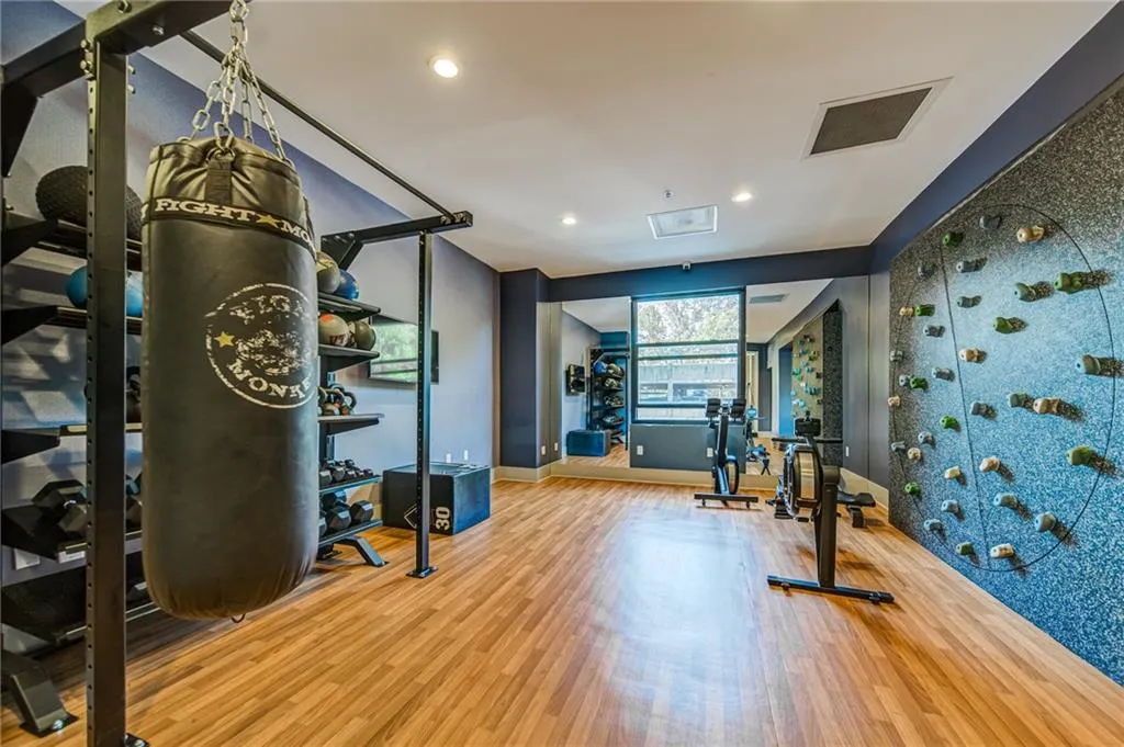 Workout area featuring wood finished floors and recessed lighting