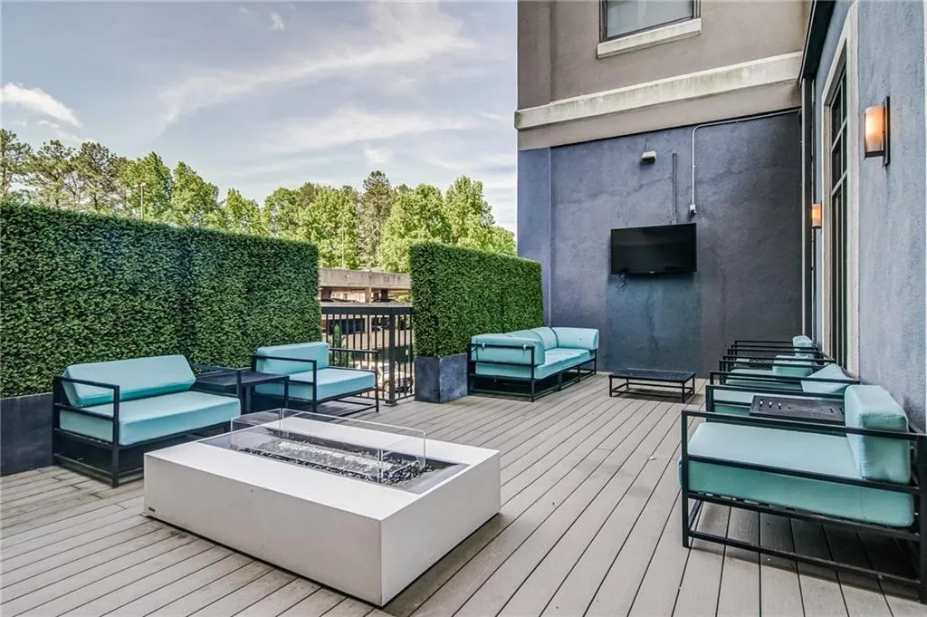 Wooden deck with an outdoor living space with a fire pit