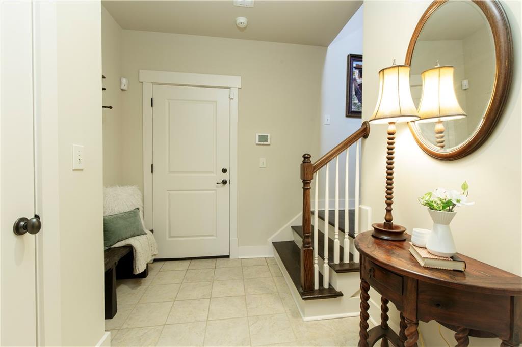 The terrace level features a practical mudroom entry from the 2-car garage and an additional ensuite bedroom with a full bath.