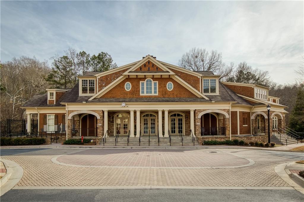 Highlighting the impressive two-story clubhouse within the community, a focal point of luxury and social activity, featuring a variety of amenities such as meeting rooms, a fitness center, spa, catering kitchen and entertainment spaces, designed to enhance the living experience for all residents.