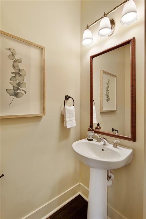 Featuring the conveniently located half bath, discreetly tucked in near the formal living room, providing easy access for guests while maintaining the flow and elegance of the home's design.