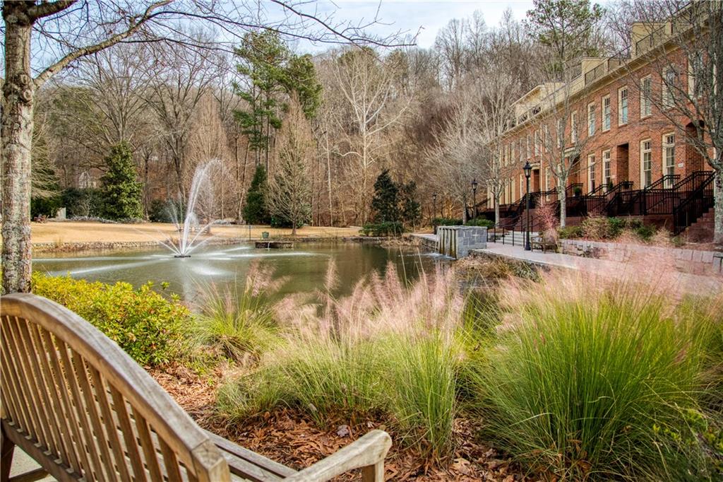 Featuring the picturesque sidewalk along the tranquil pond, an ideal setting for leisurely walks with pets, offering a peaceful and scenic environment for both residents and their furry companions to enjoy the beauty of nature.