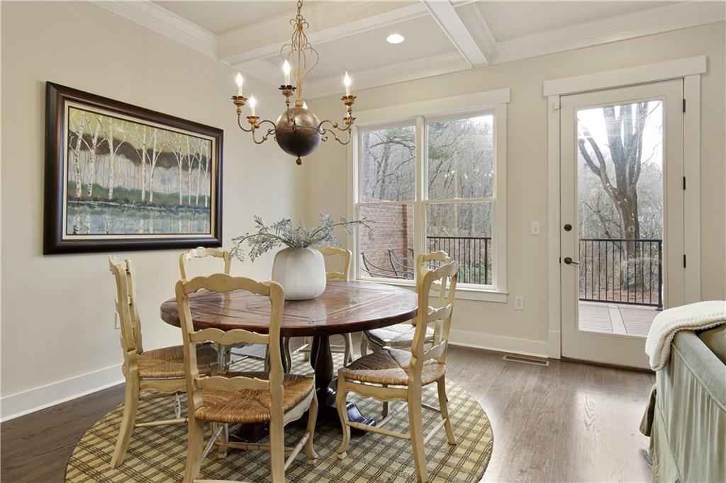 Capturing the elegant separate dining area, designed with large windows that offer a picturesque view of the deck, allowing for a delightful dining experience that connects the indoor space with the tranquil outdoor setting.