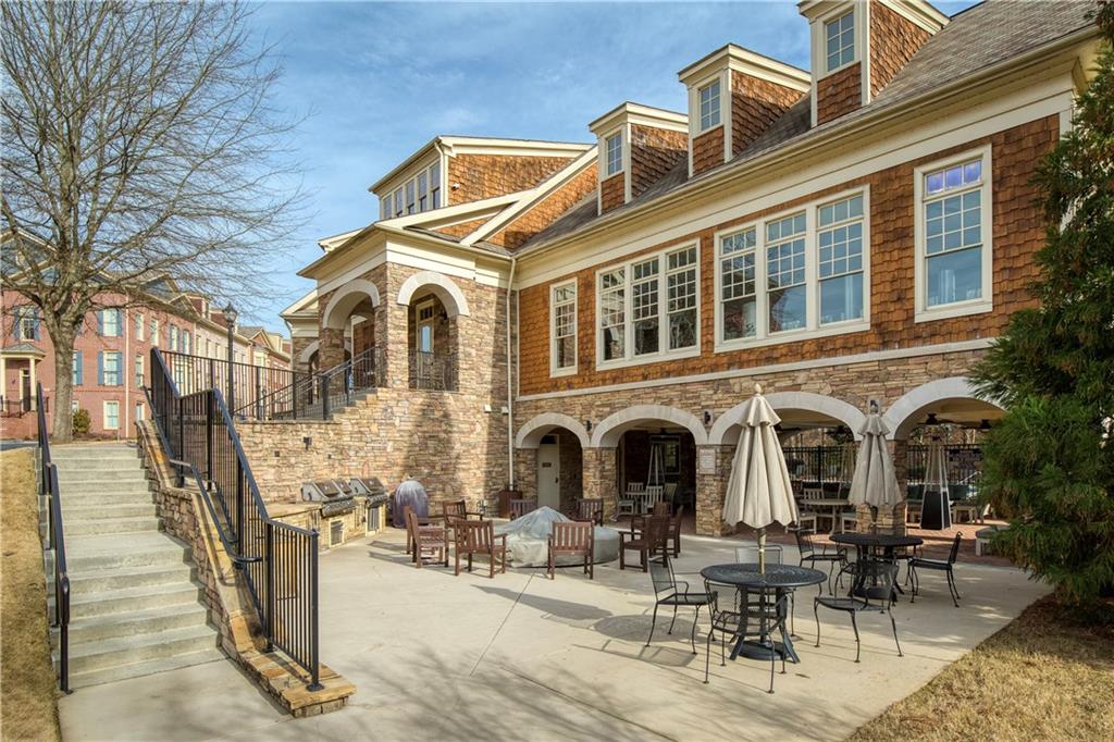 The inviting community fire pit area, a perfect spot for gatherings and relaxation, where residents can enjoy warm, cozy evenings outdoors, socializing and experiencing the comforting ambiance of an open fire.