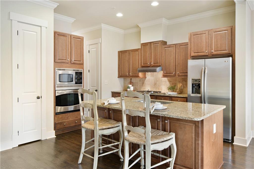 The versatile kitchen island is perfect for meal preparation and ideal for casual dining or quick meals, combining functionality with a modern, social atmosphere.