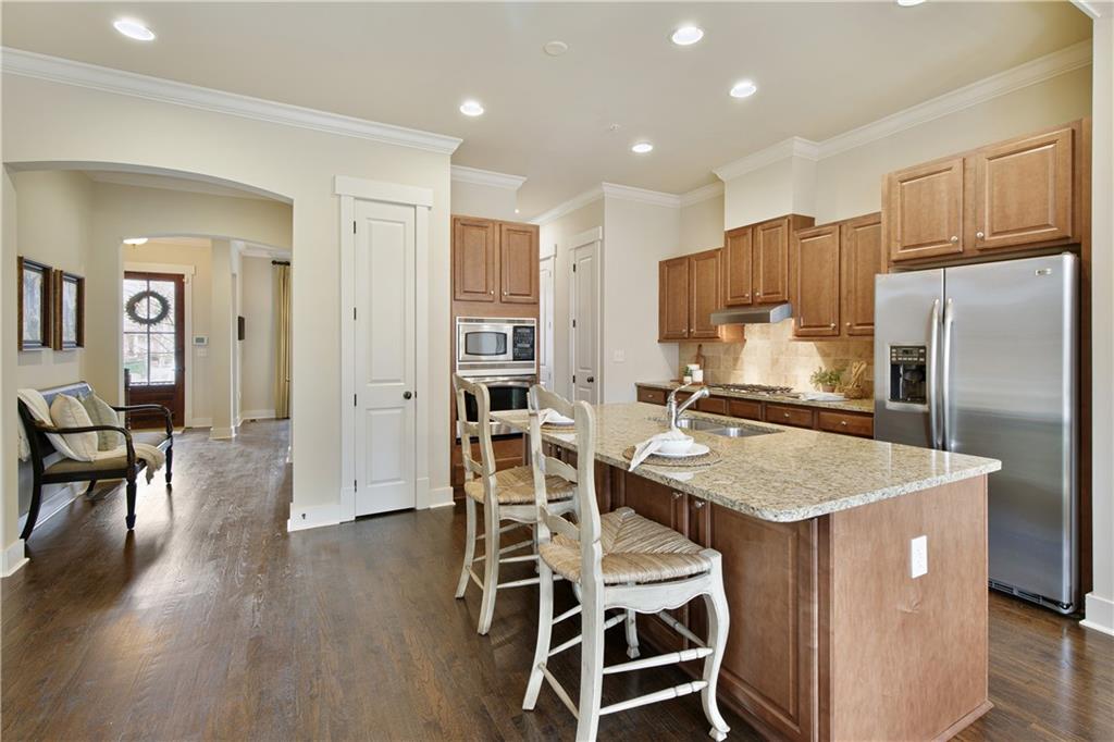 Welcome to the stunning kitchen area with a large island, stainless-steel appliances, and granite countertops, ideal for modern living and entertaining.