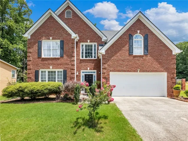 Traditional brick exterior featuring multiple gables and white trim accents