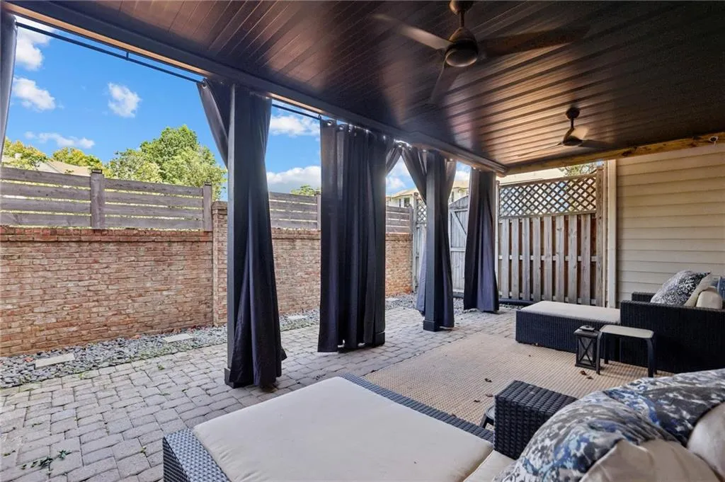 Patio off terrace level. Under-deck system includes ceiling fans and multi-material privacy wall.