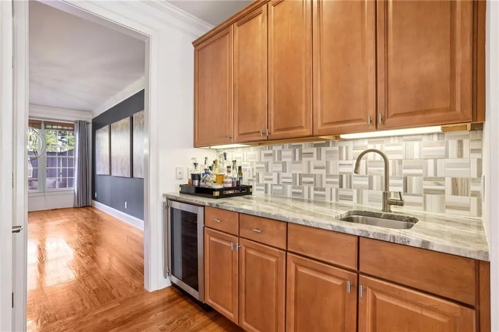 Butler pantry/bar with wine fridge. This room transitions the formal dining room and kitchen.