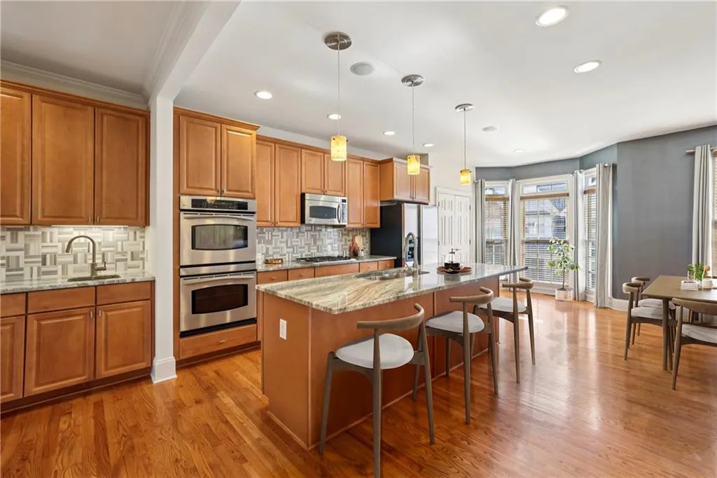 Gorgeous kitchen with stained cabinets and large breakfast bar. Double oven.