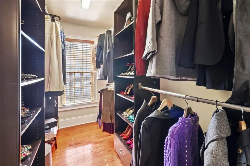 1 of 2 primary bedroom walk-in closets with custom built-ins.