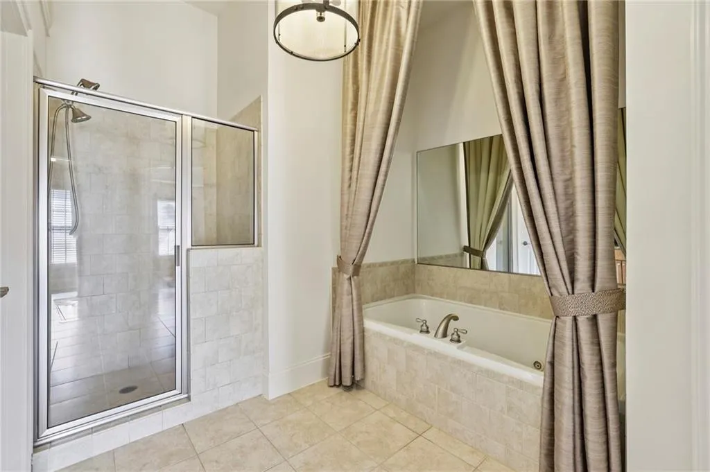 Primary bedroom with separate shower and soaking tub.