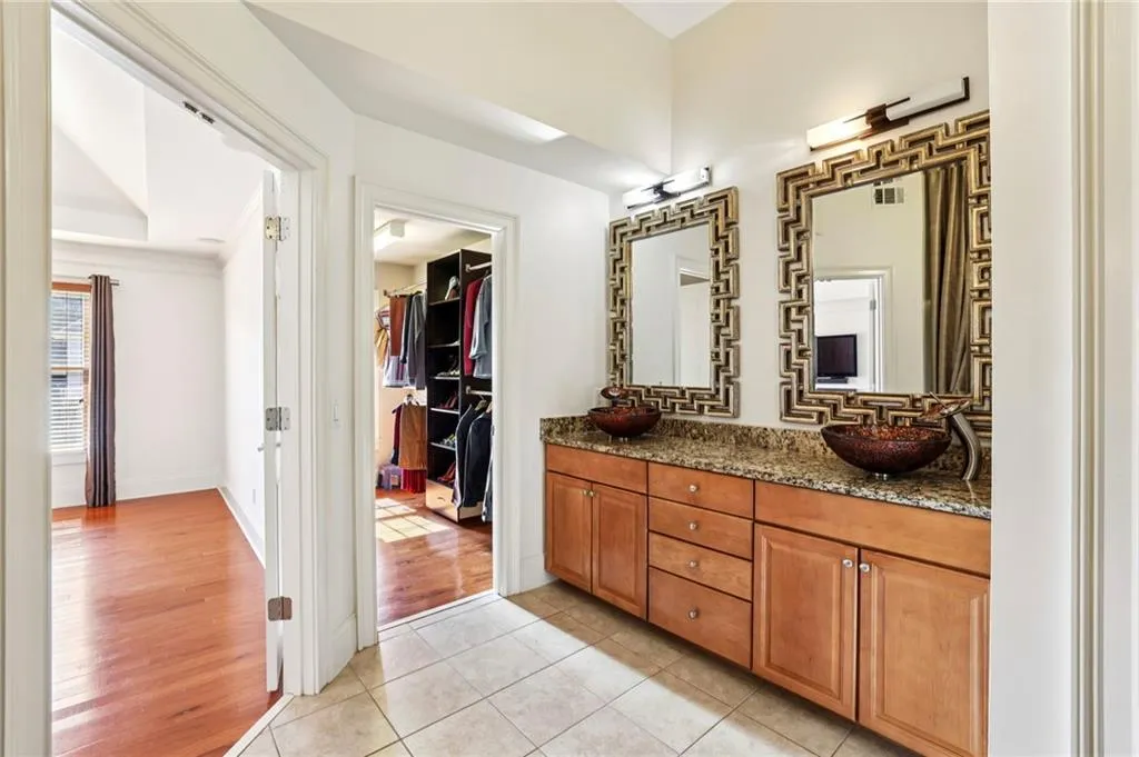 Primary bedroom bath with view toward 1 of 2 walk-in closets.