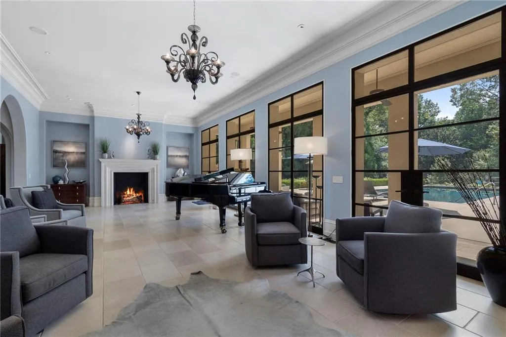 Double french doors open to a covered patio and the pool.