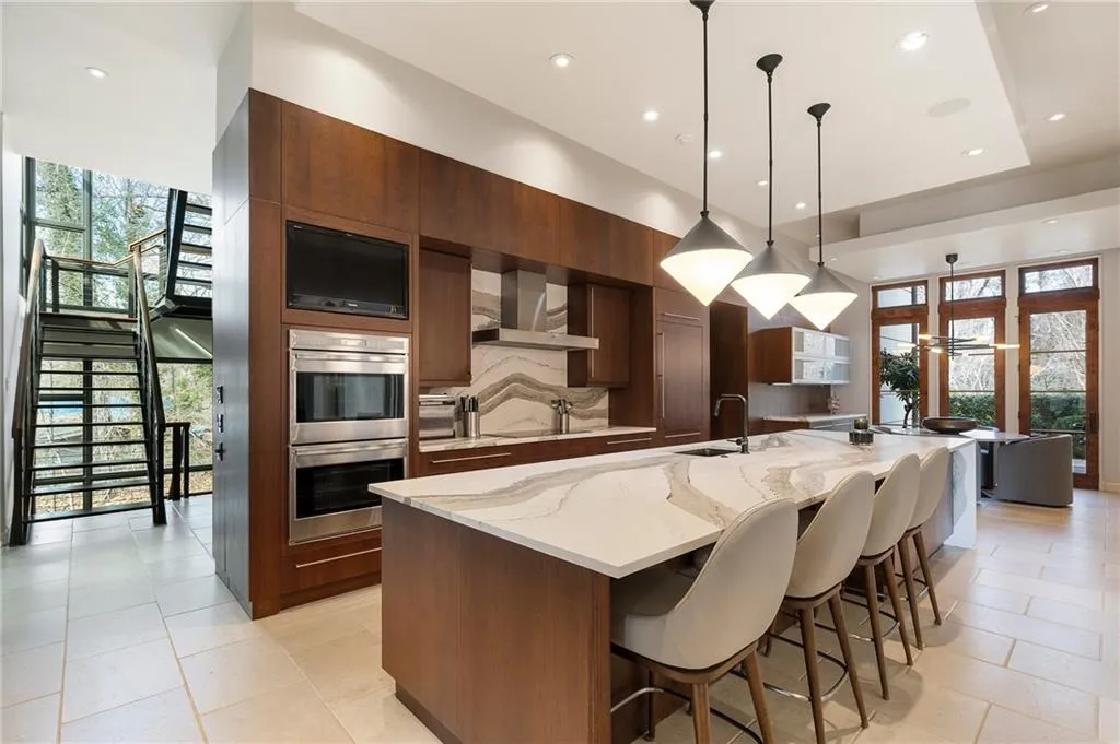 Massive island with seating and plenty of prep area and storage space. Breakfast room at the end and coffee bar on the other end.