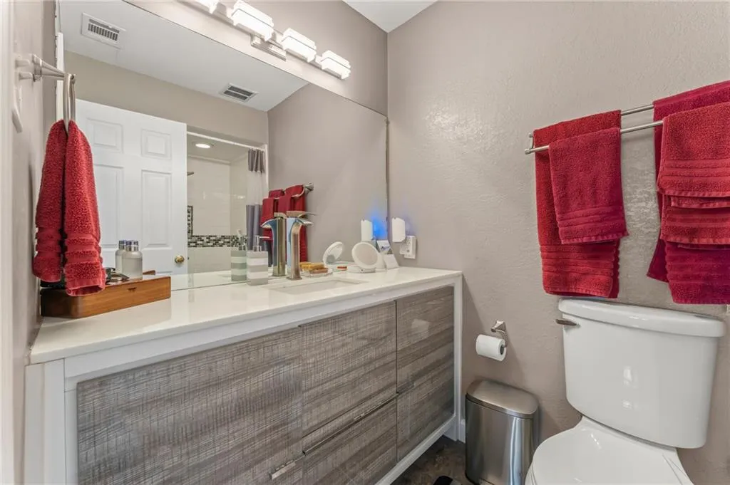 Sleek Guest Bath with modern vanity and lighting fixtures.