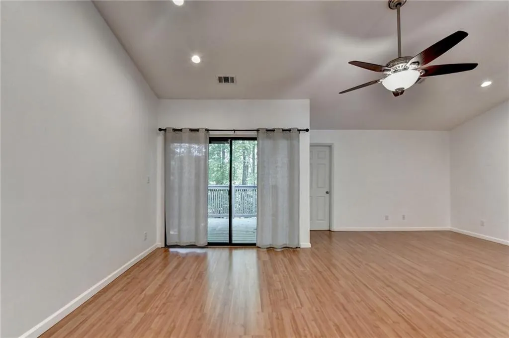 Spare room featuring ceiling fan, visible vents, light wood-style floors, baseboards, and recessed lighting