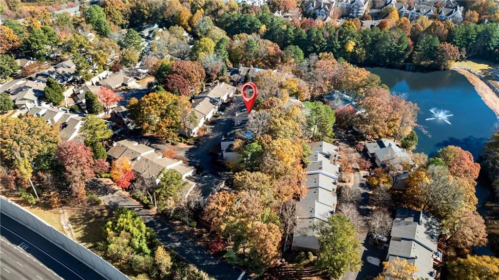 Aerial view of property and surrounding area with nearby suburban area and a nearby body of water
