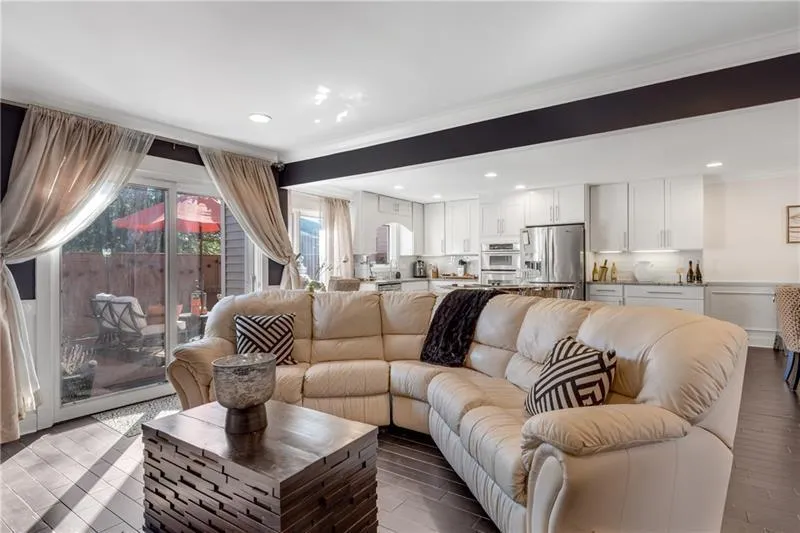 View of Family Room open to Kitchen & Sliding Doors to Private Deck.