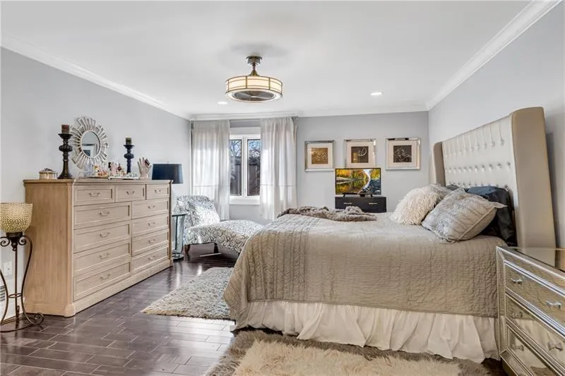 Primary BR with Hardwood Floors, Fandolier & Crown Moulding.