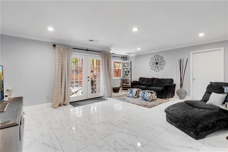 Main Level Bonus/BR/Flex Rm boasts Recessed Lighting, Carrera Marble Floor, an Oversized Walk-In Closet & Double French Doors to a Private, Covered Patio.