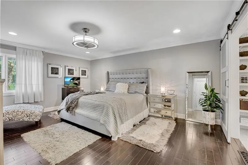 King-Size Primary Bedroom Suite features Hardwood Floors, Crown Moulding & a New Fandolier!