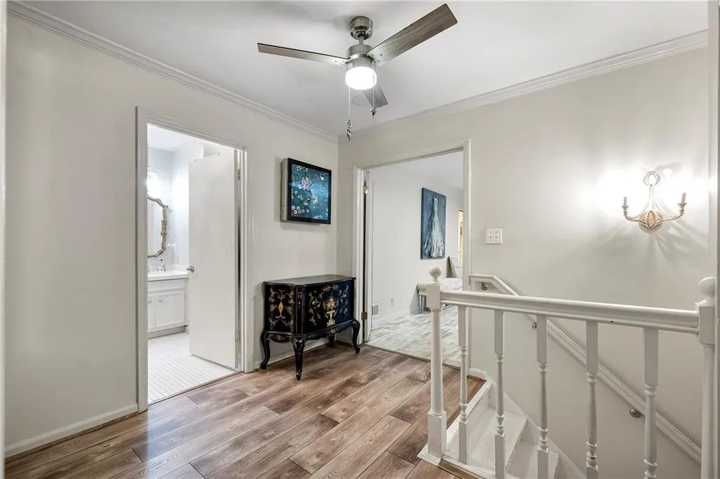 Upstairs Landing to 3 Bedrooms with ornamental molding and light hardwood / wood-style floors