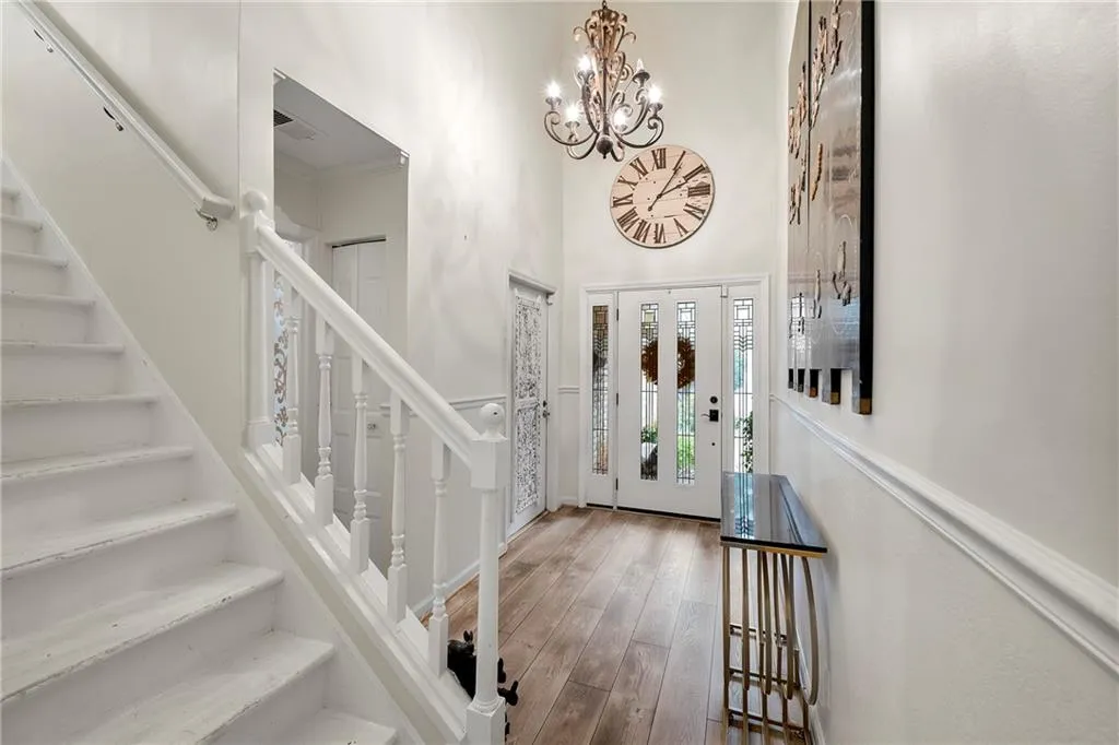 Foyer featuring a notable chandelier, a towering ceiling, and hardwood / wood-style floors