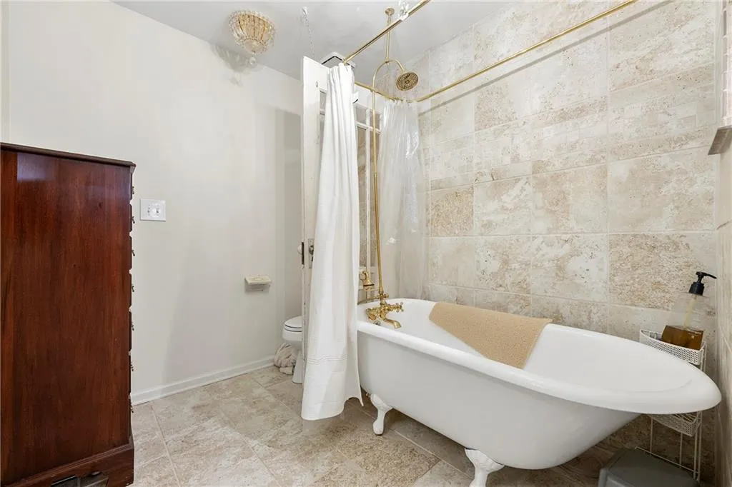 Master Bathroom featuring toilet and shower / bath combination