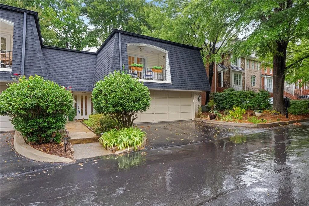 View of front of property with a balcony and a garage