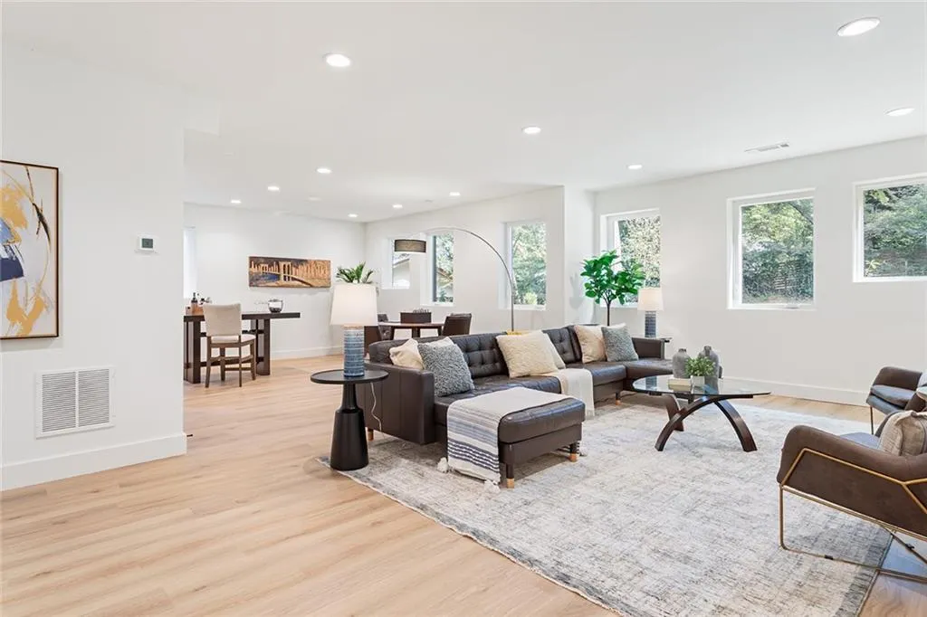 Living area featuring light wood finished floors and recessed lighting