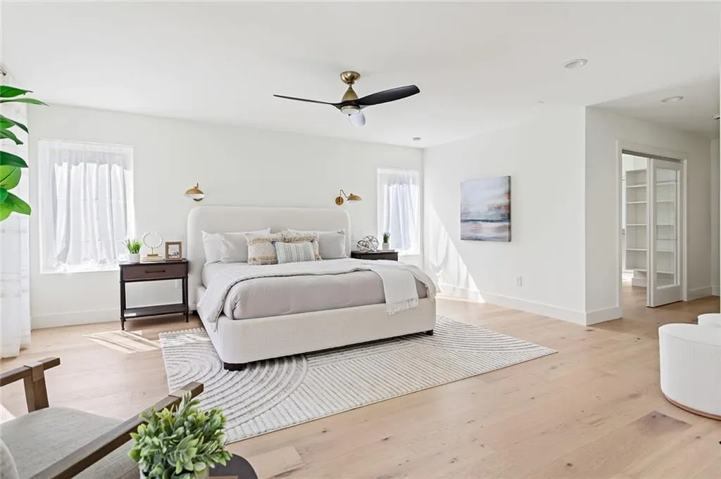 Bedroom featuring light wood-type flooring, a ceiling fan, and recessed lighting